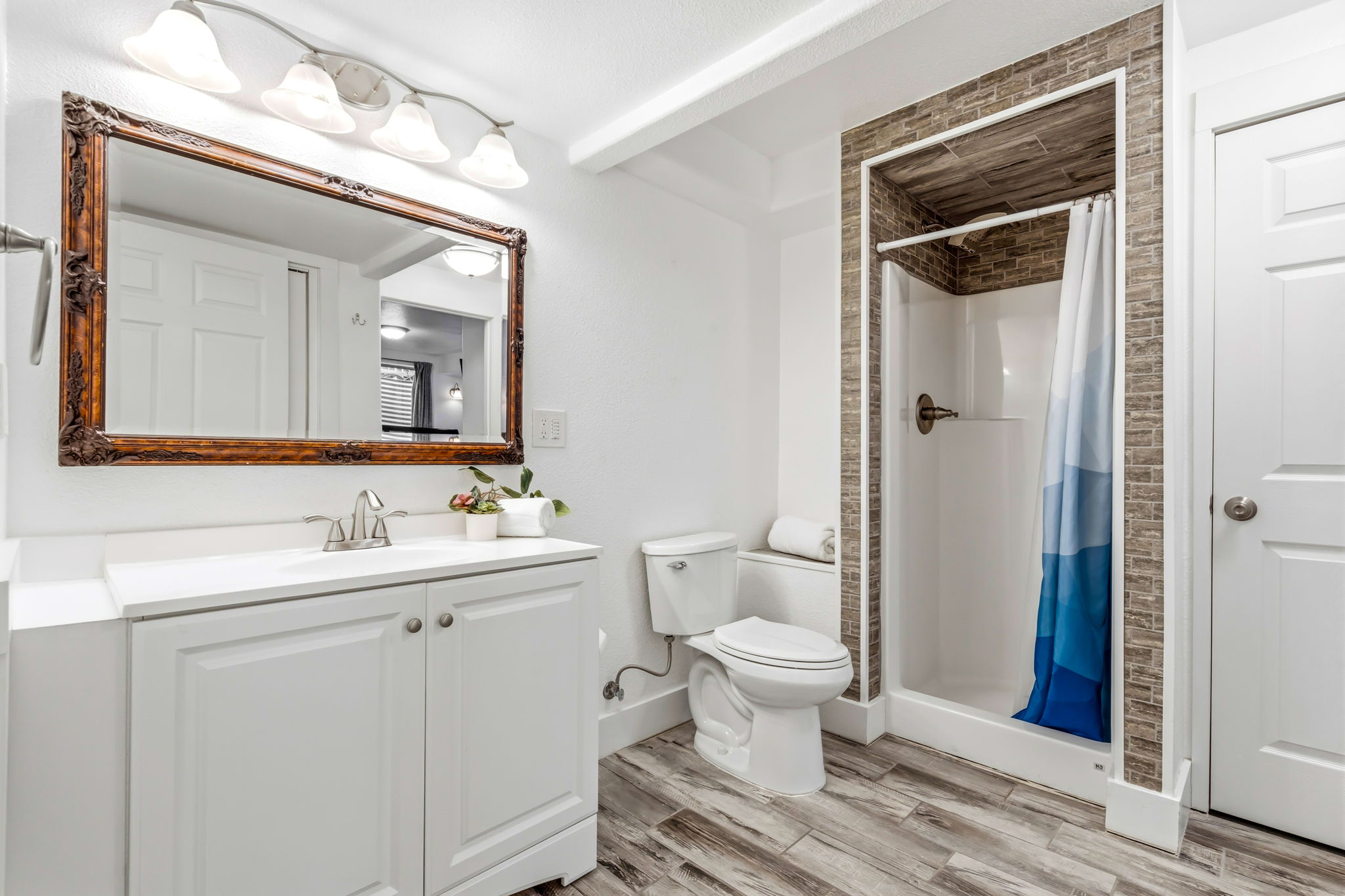 Basement bathroom with walk-in shower and laundry room access.