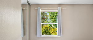 Bedroom has view of trees