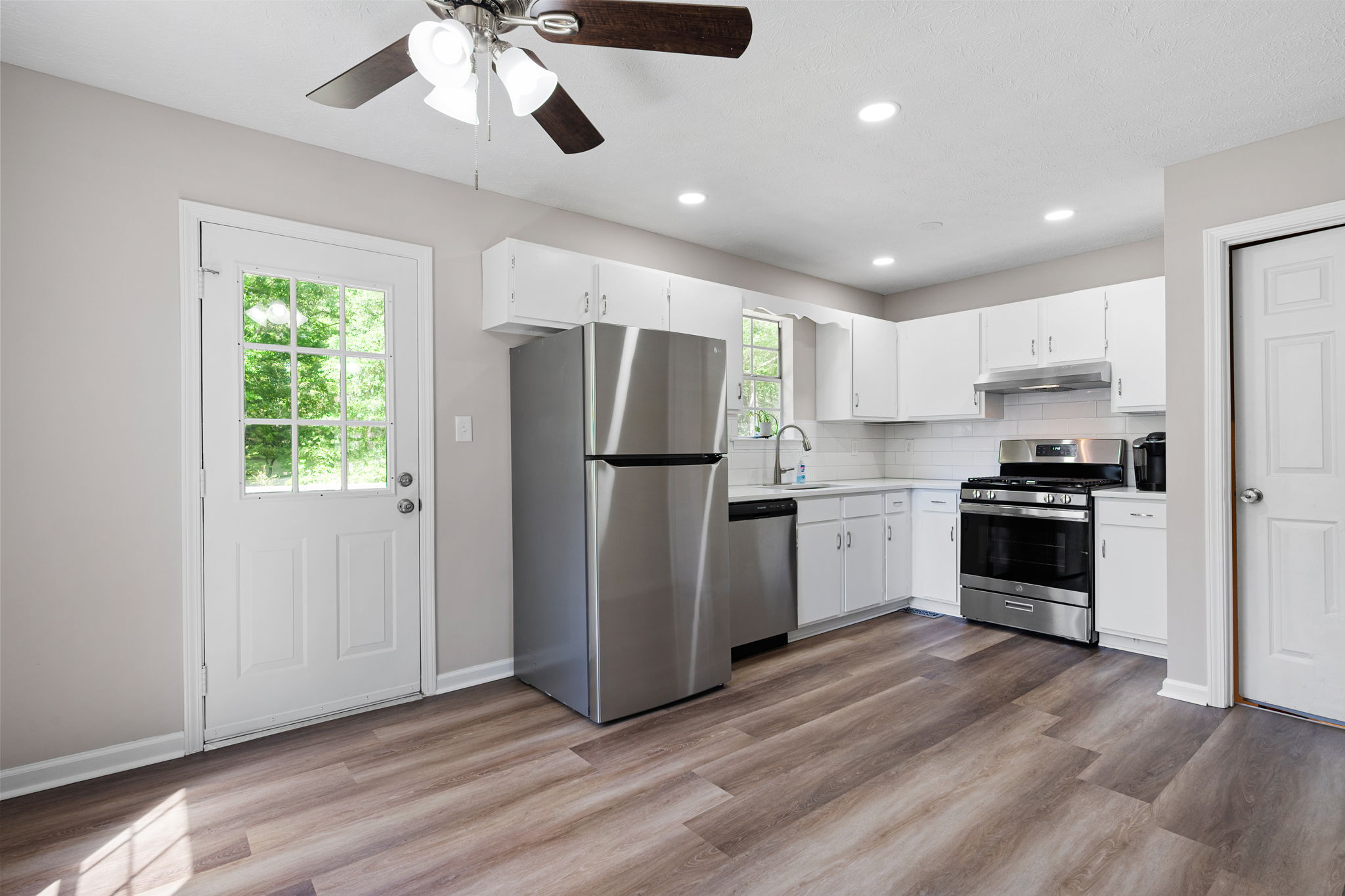 The renovated kitchen boosts new cabinet doors, new quartz countertops...