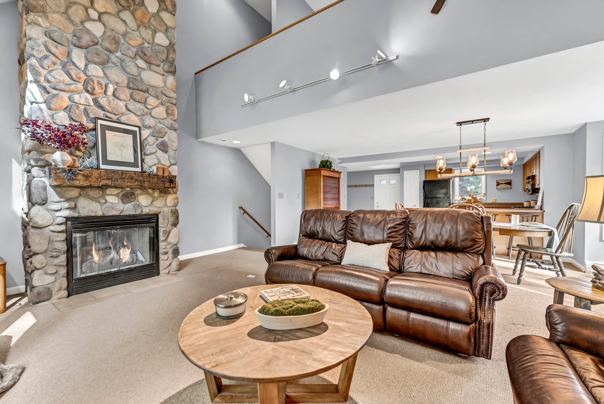 Soaring 2 story river rock mantel