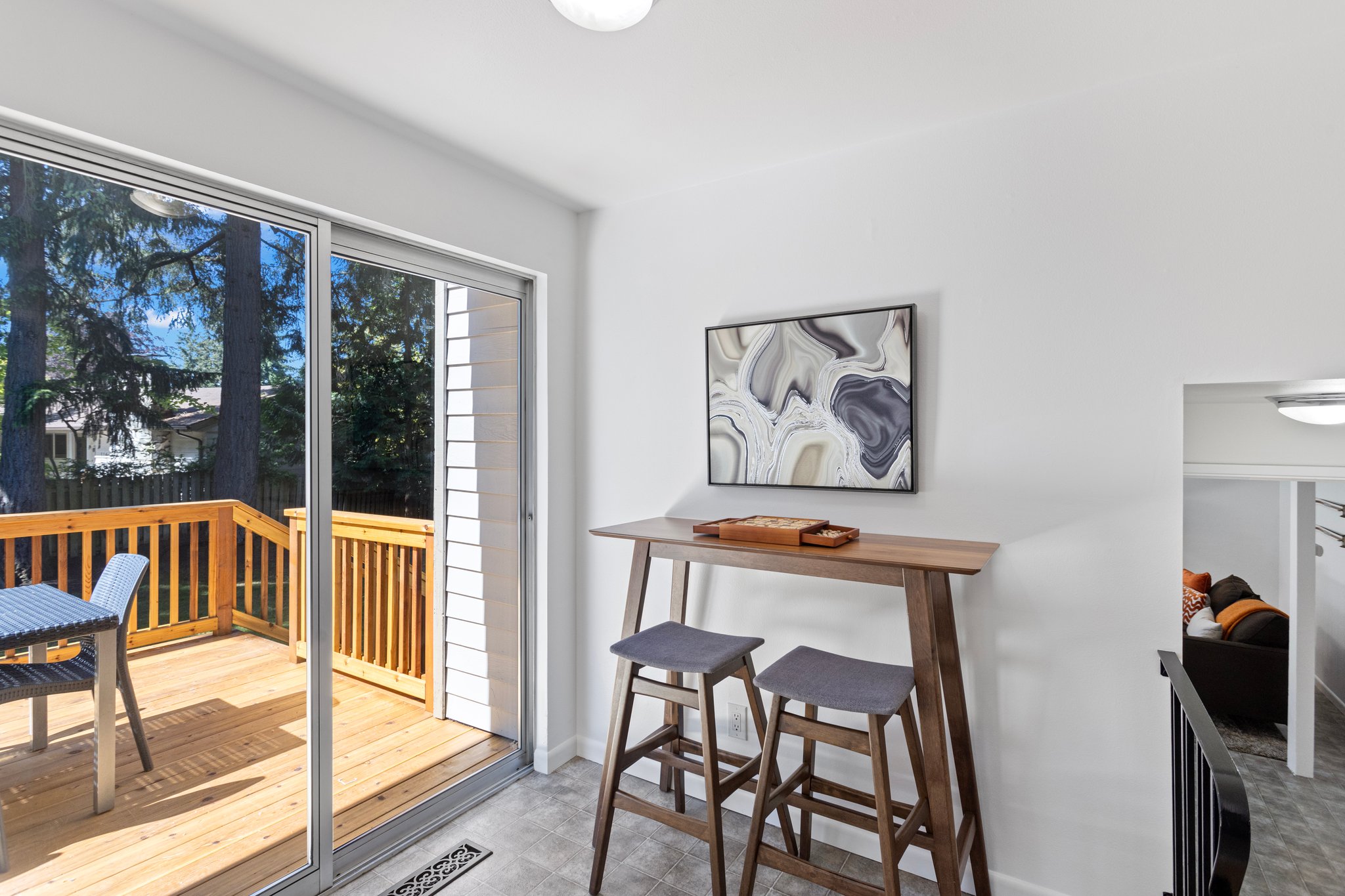 The sunny kitchen eating space connects with the family room and opens out to the deck.
