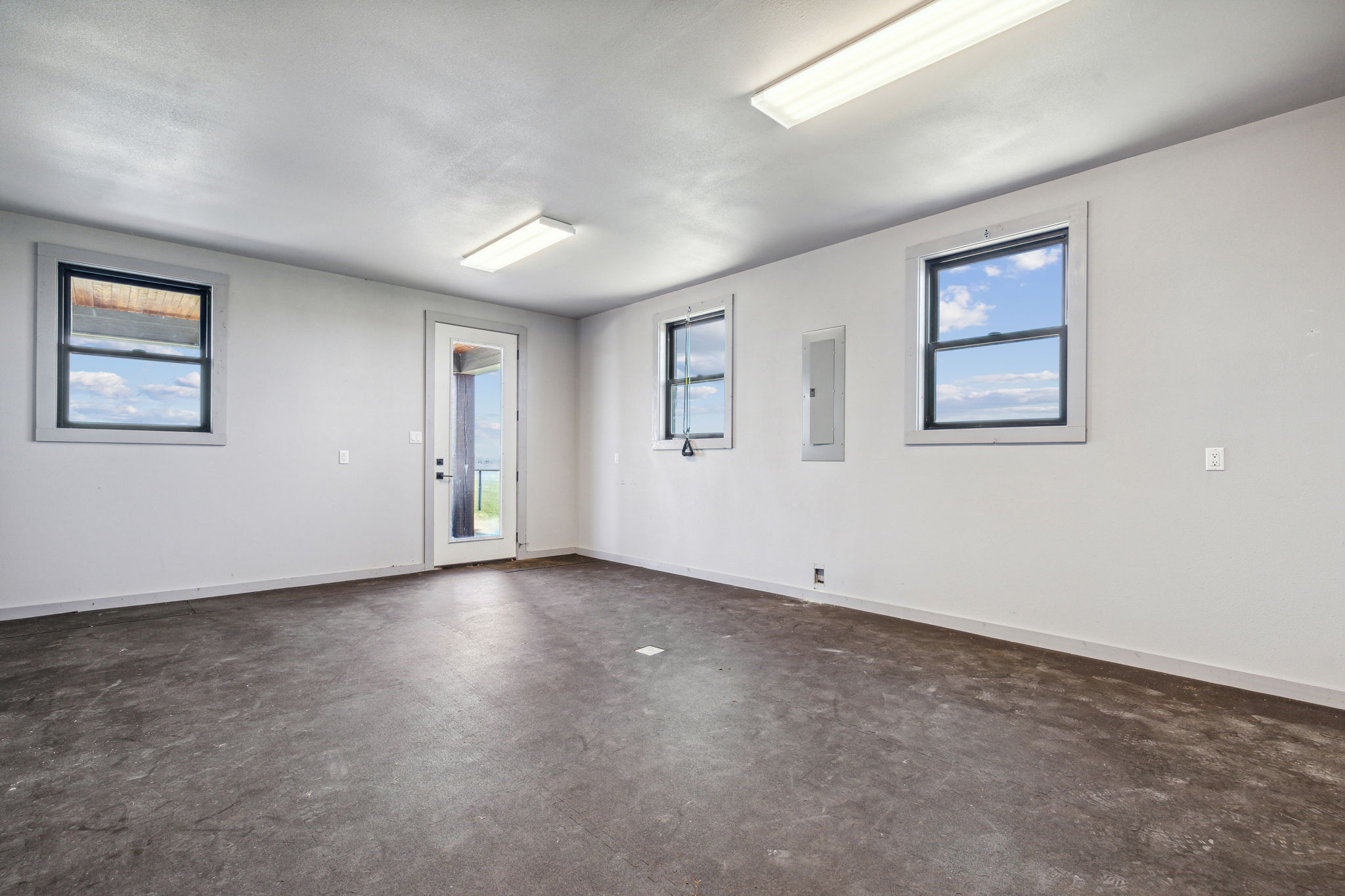 Exercise Room on first floor of the Man Cave with door to a patio