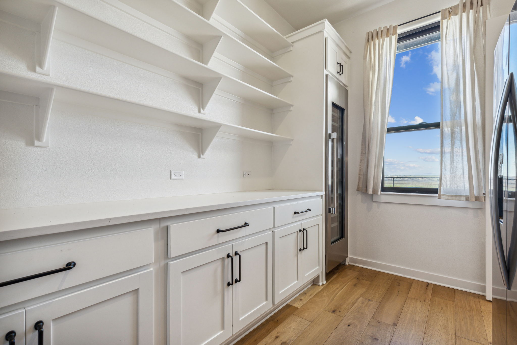 Walk in Pantry with large wine refrigerator of the Main House