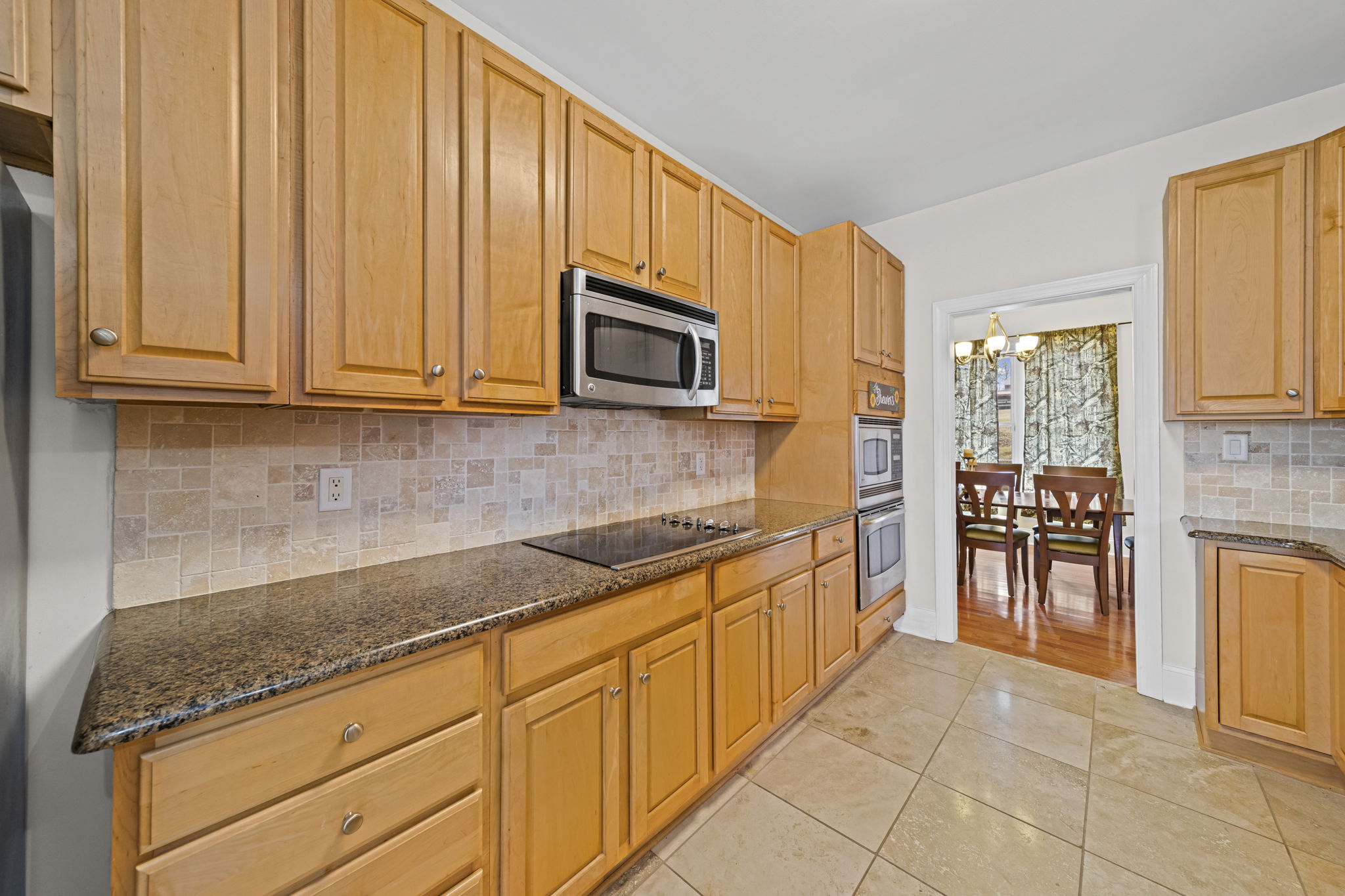 Granite countertops and tile neutral tile backsplash