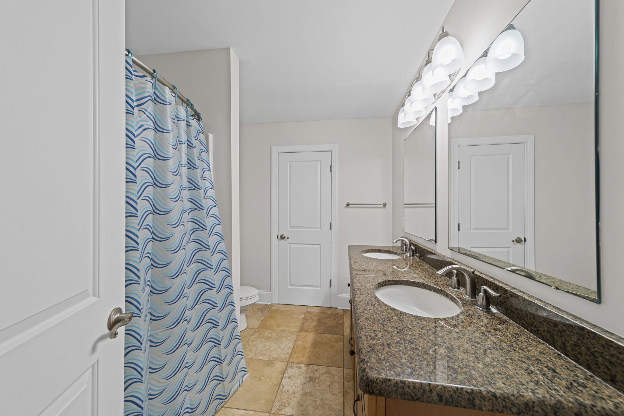 Upstairs bathroom with tub/shower and dual vanities.