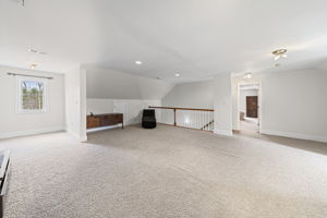 Expansive flex space upstairs looking into the bonus room.