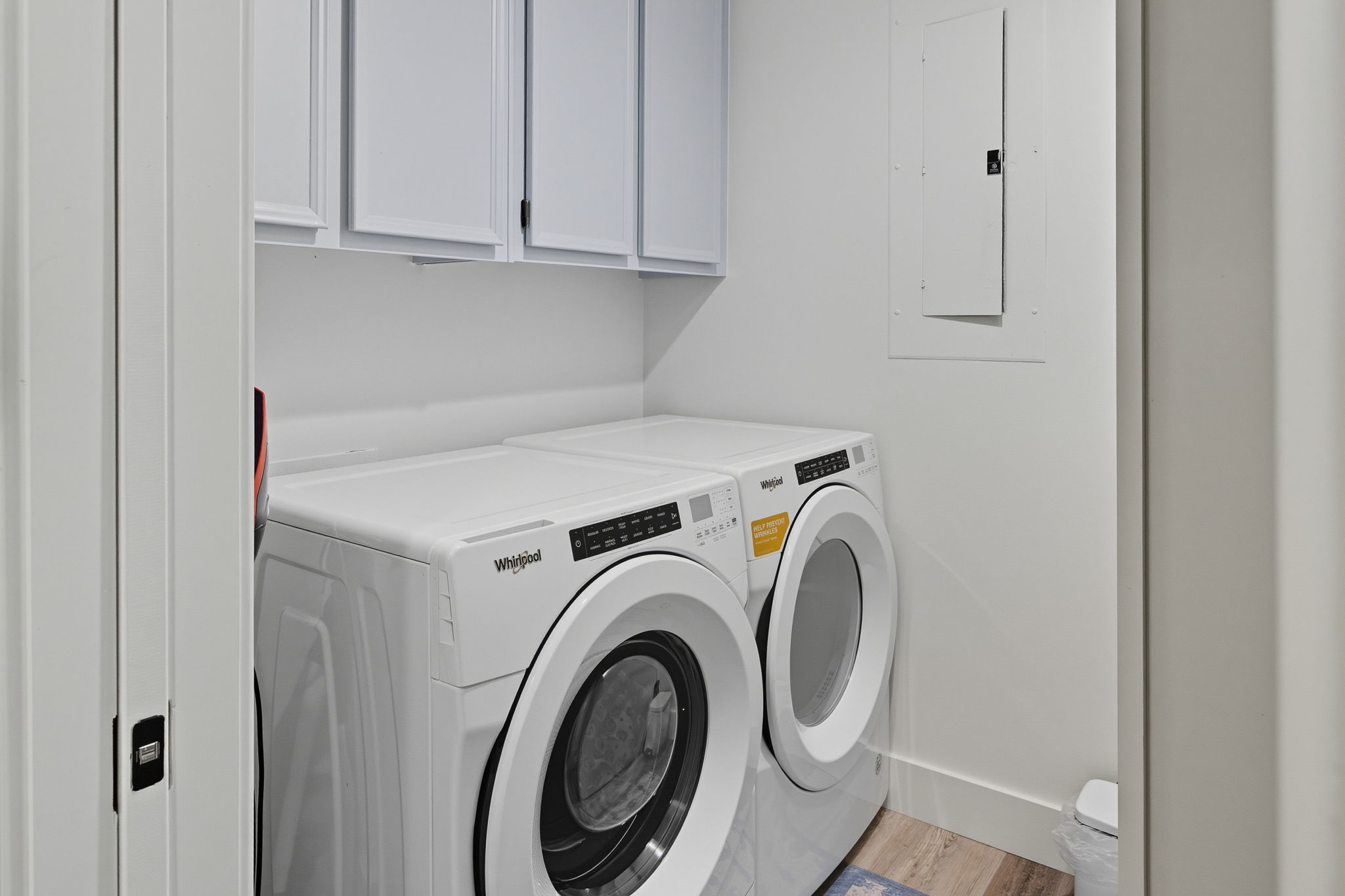 Laundry room with storage.