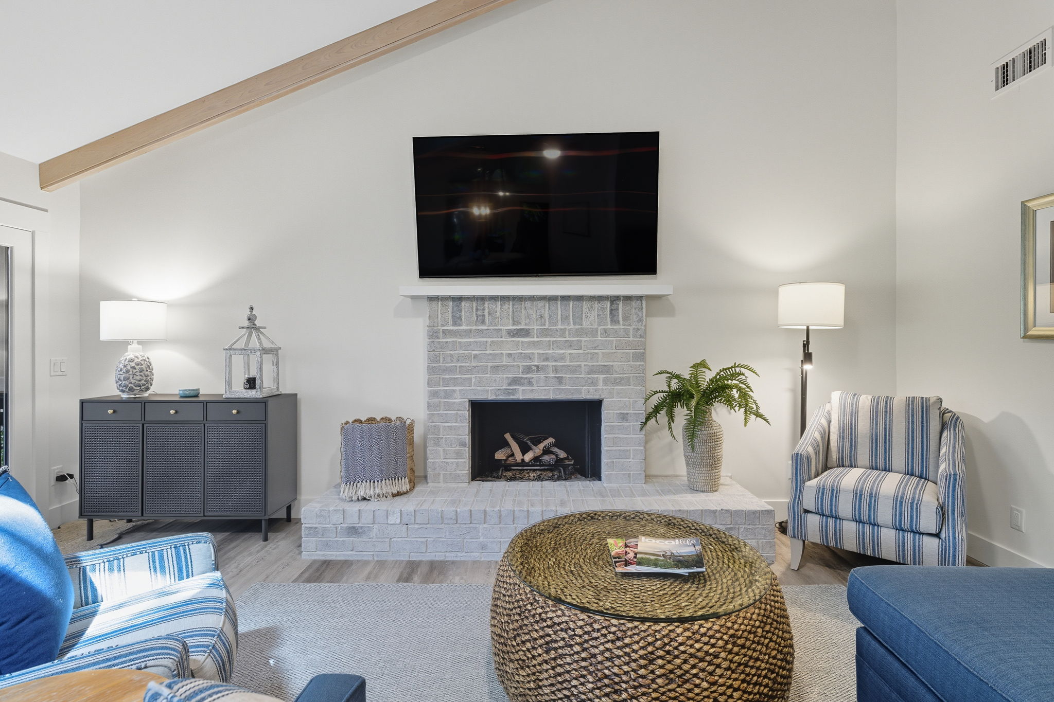 Living area with propane firplace and volume ceilings.