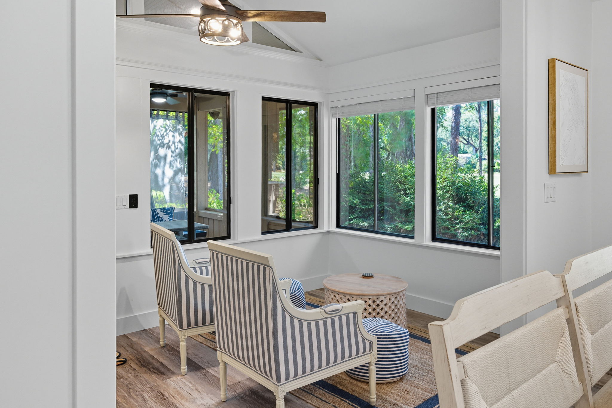 Seating area with screened-in porch in the background.