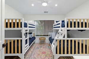 Bunkroom with 3 twin beds and 1 full bed.