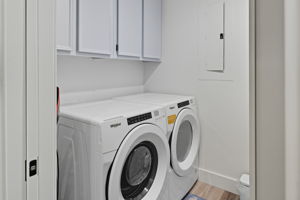 Laundry room with storage.