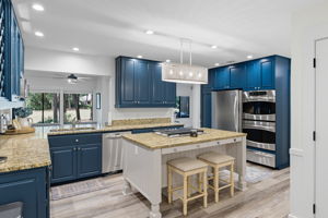 Kitchen with seating @ the island and double ovens.