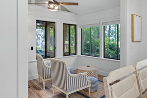 Seating area with screened-in porch in the background.