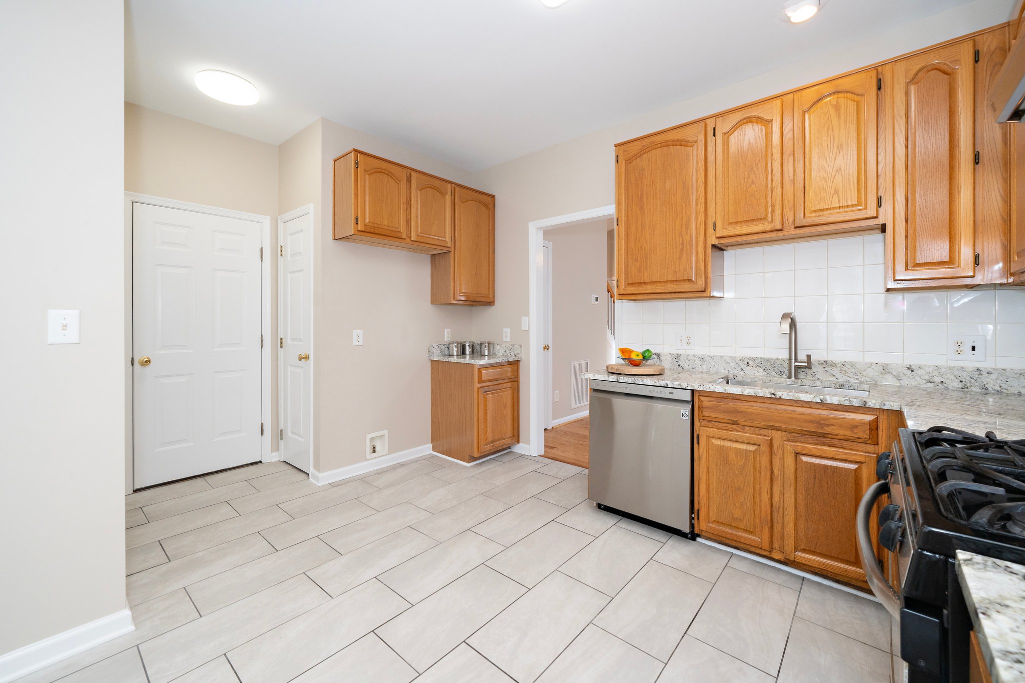 The Kitchen features new granite counters, a new stainless sink and faucet . . .