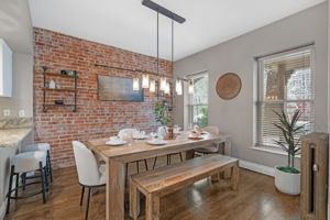 Gorgeous dining room with exposed brick