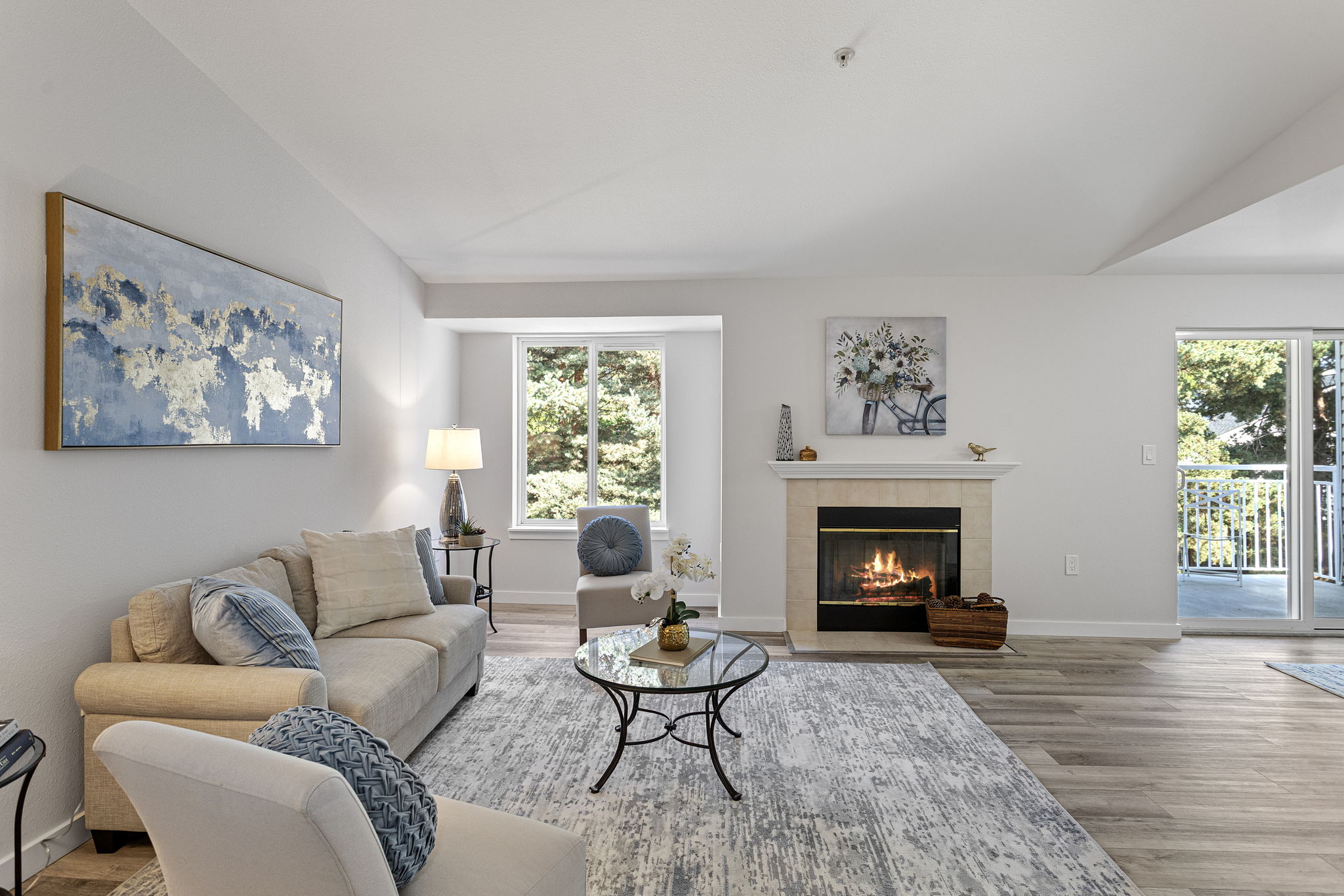 The living room centers on the fireplace, with the dining area and covered balcony just beyond.