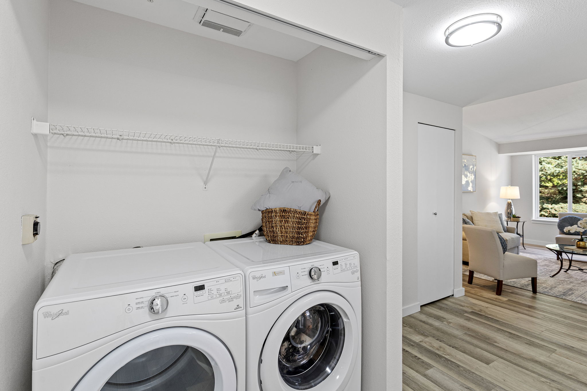 “But where are the laundry doors?” The included side-by-side front-loading washer and dryer are simply too large for them. The brand-new doors are stored in the balcony storage room, giving the next owner a choice: keep the full-size machines as-is, or switch to a smaller set and put those new doors to use.