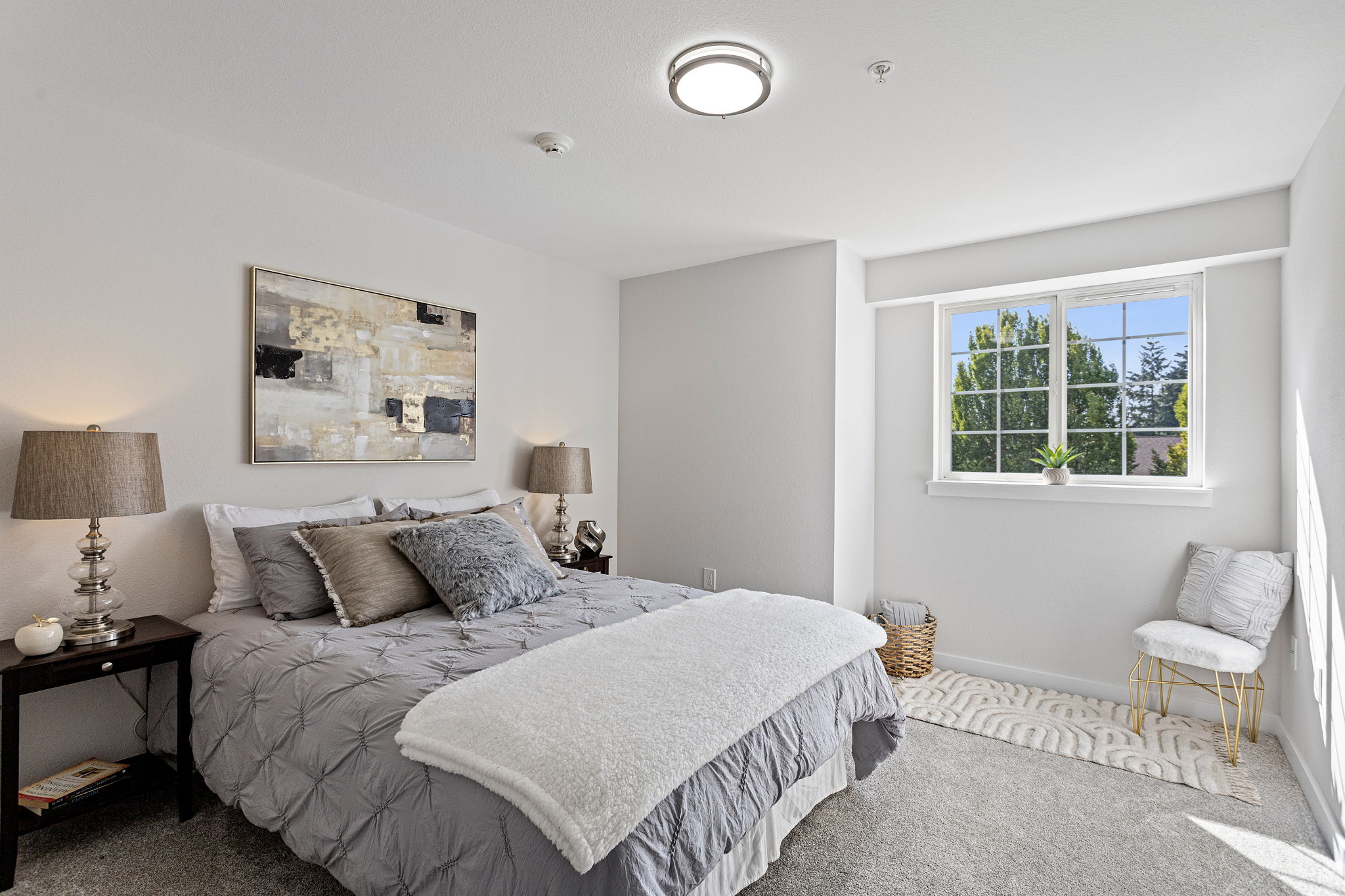 A sunny window bump-out creates a natural sitting or reading nook in the generous primary suite, with west-facing afternoon light, a separate dressing/closet zone with new vanity and lighting, and a private bath.
