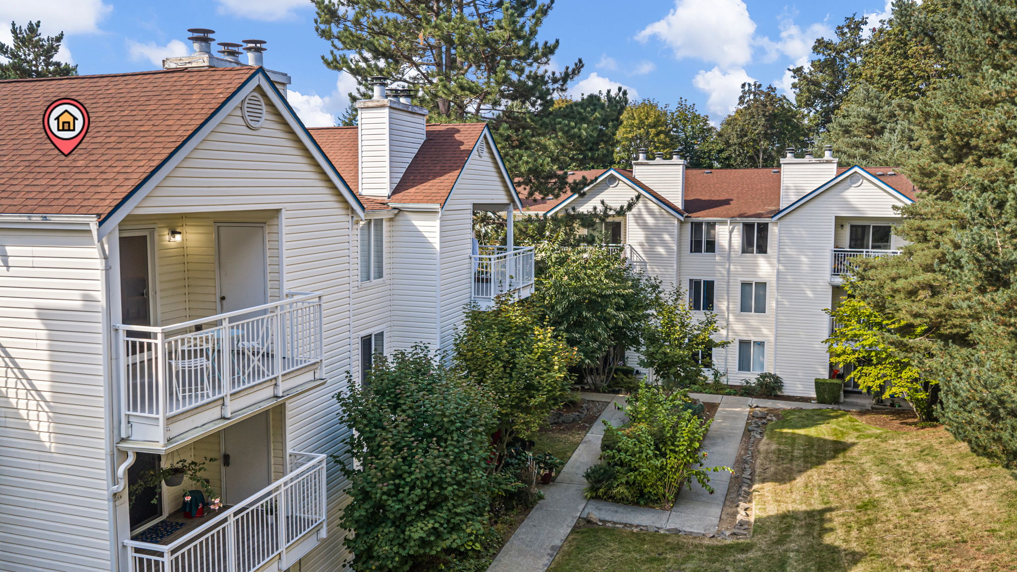 From above, you can see why the balcony feels more private: D302 sits over the landscaped courtyard and bumps out beyond neighboring sightlines, so the space feels less exposed and more your own. The open courtyard between the balcony and mature trees gives the view real depth—green, light, and room to breathe.