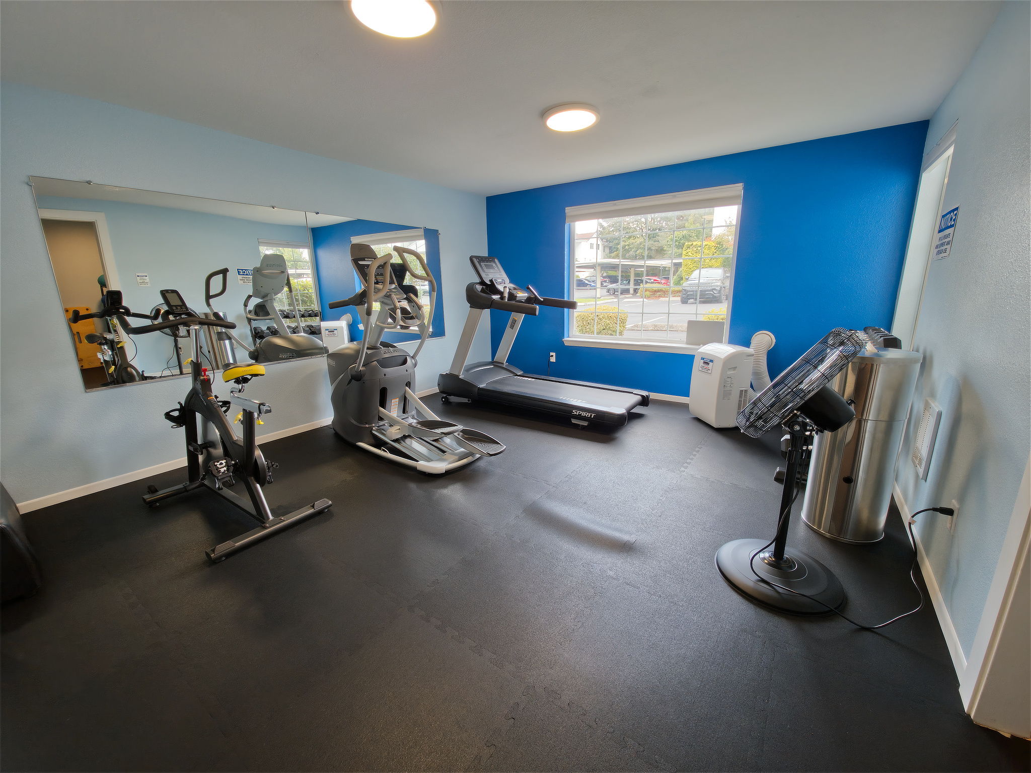 The clubhouse fitness center includes cardio and strength equipment, free weights, and a portable air conditioner for added comfort.