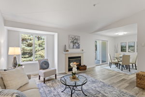 Morning light, vaulted volume, and a sightline that keeps going—through living and dining to the covered balcony and trees beyond.