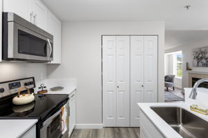 From the kitchen, the sightline carries through to the living room and fireplace.