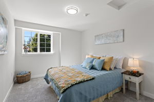 A generous second bedroom gives you options—guest room, home office, or a little of both—with new carpet and padding, new molding, new doors, and west-facing light later in the day.