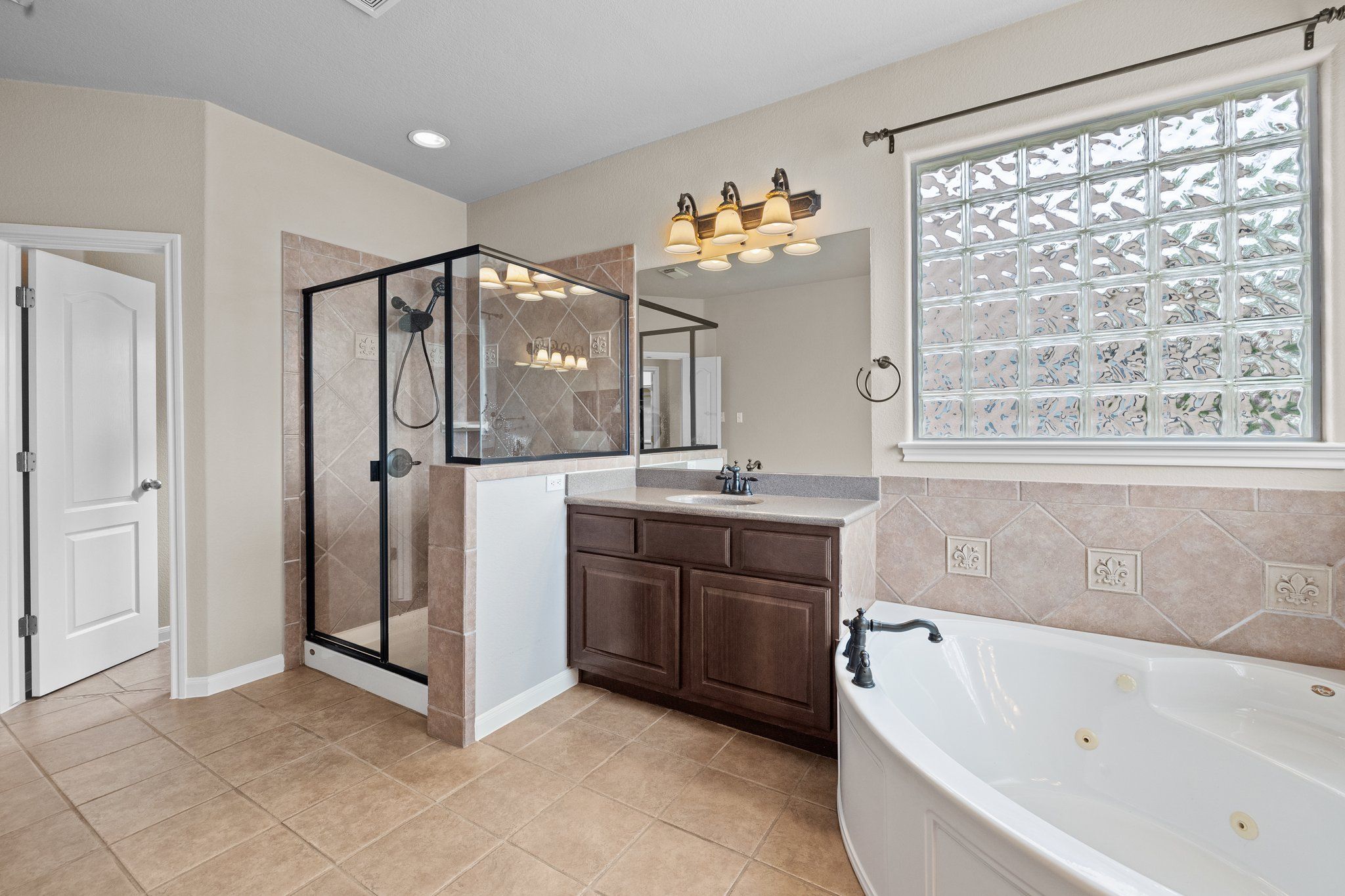 Lovely master bathroom with two sinks, large walk-in shower, jetted tub