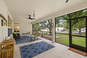Have your morning coffee on this lovely screened in porch.