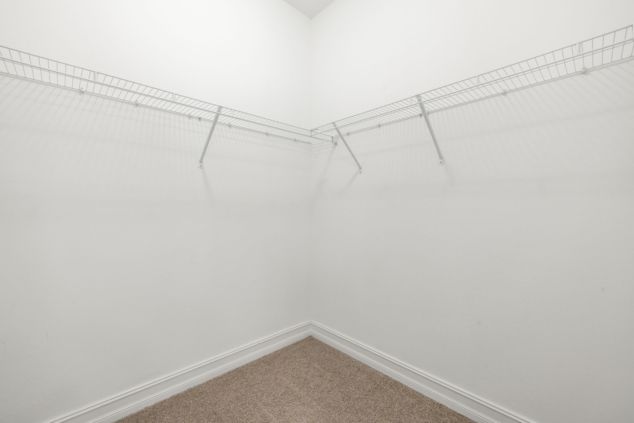 Primary bedroom walk-in closet