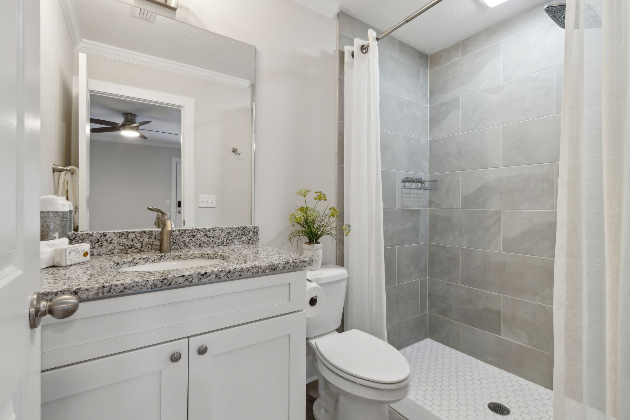 The master's ensuite bath features elegant wall-to-ceiling tiled shower ...
