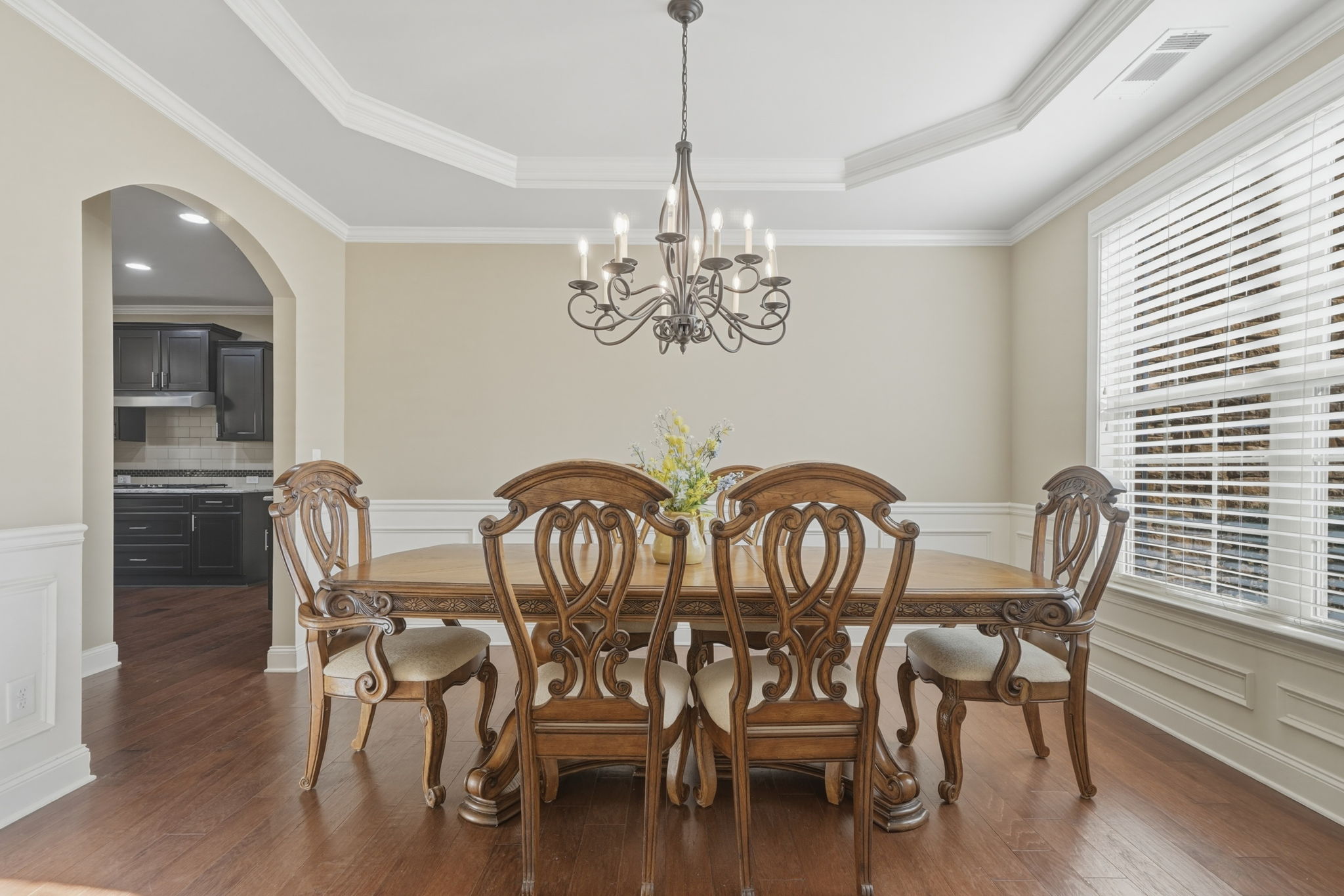 Separate Dining Room features wainscoting and trey ceiling