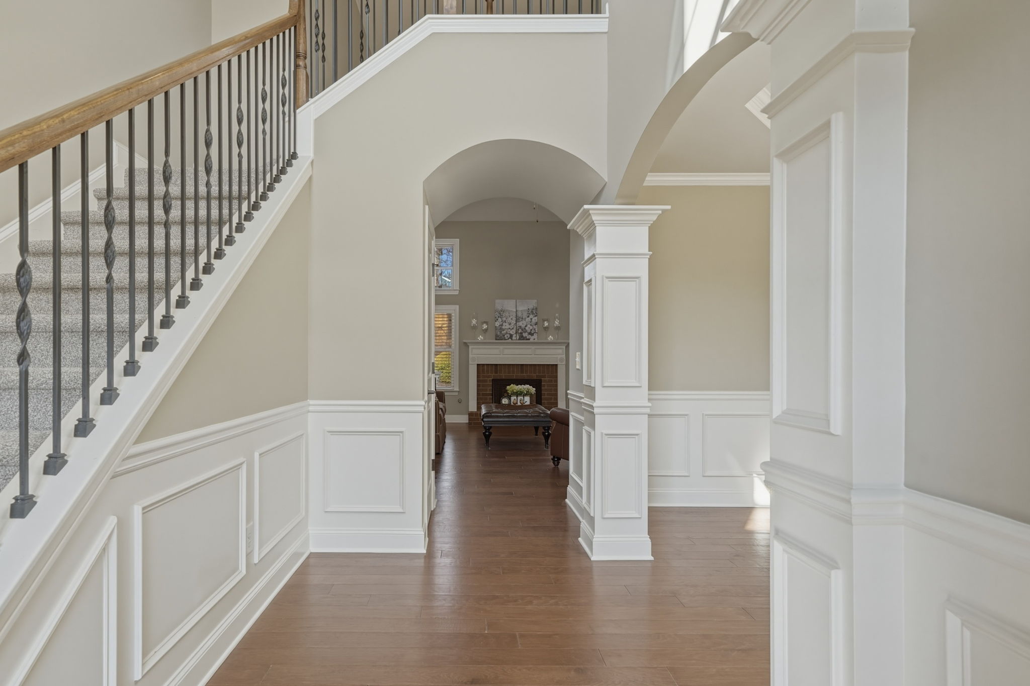 Bright and open Foyer with gleaming hardwood floors and fabulous trim work