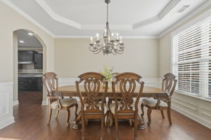 Separate Dining Room features wainscoting and trey ceiling