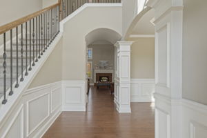 Bright and open Foyer with gleaming hardwood floors and fabulous trim work