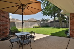 Patio area overlooking the fenced backyard