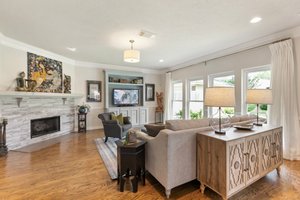Another view of family room with fire place and built in shelf