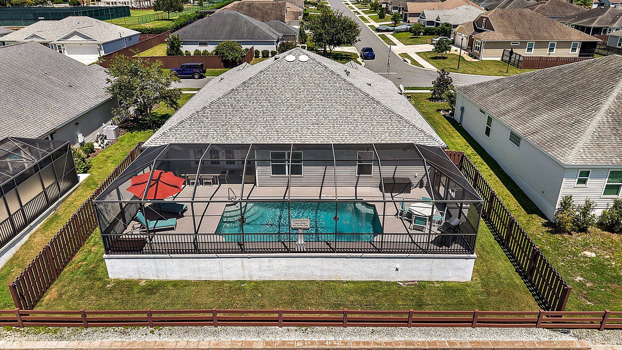 Rear Elevation Aerial View of Pool with Fenced Yard