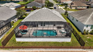 Rear Elevation Aerial View of Pool with Fenced Yard