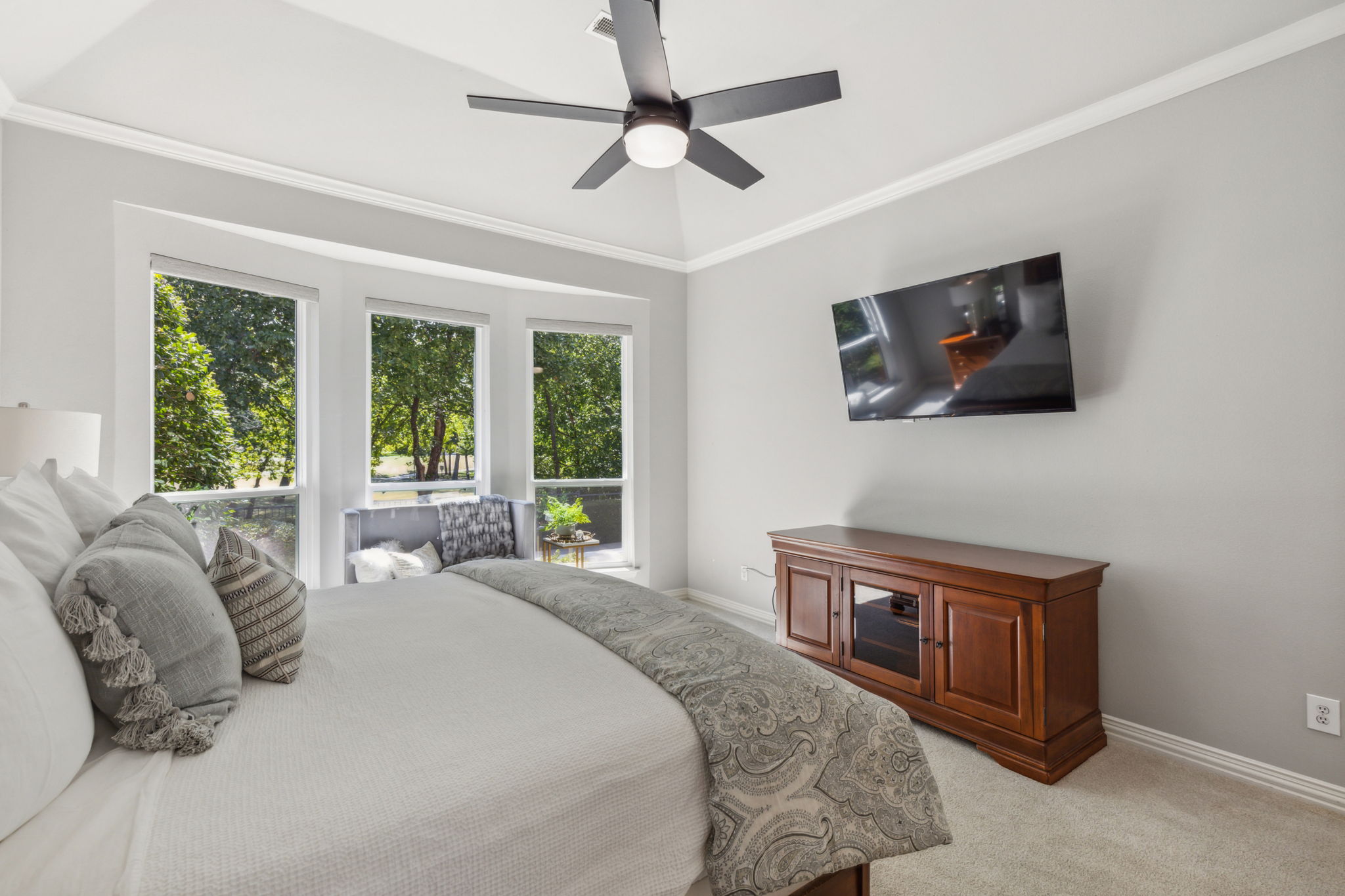 Another angle of the primary bedroom with updated ceiling fan.