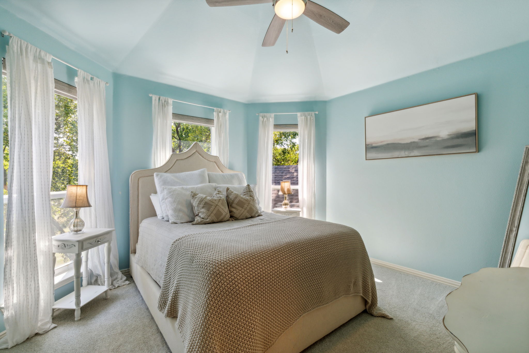 Bedroom #3 has sweeping views of the backyard, a new ceiling fan, and a vaulted ceiling.