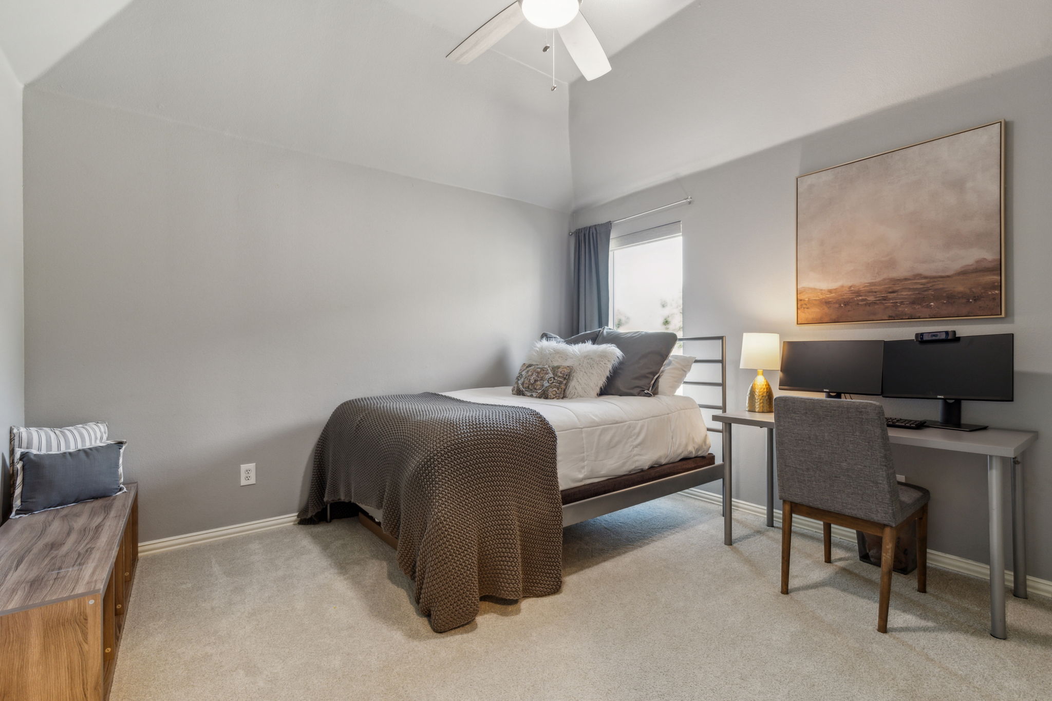 Bedroom #4 has vaulted ceilings, a new ceiling fan, and ample space for a desk, along with a walk-in closet.