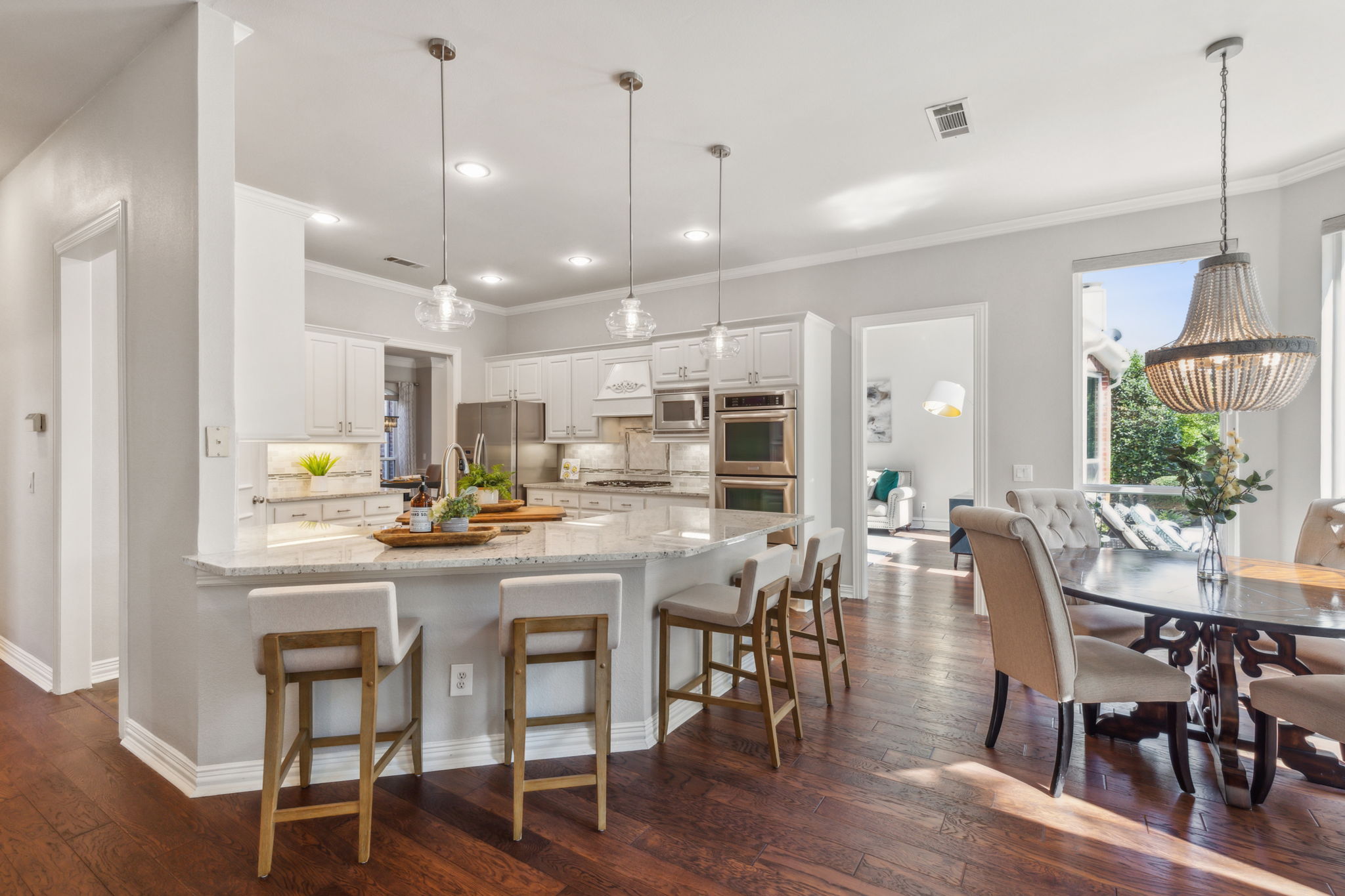 The updated kitchen features stainless steel appliances, elegant light fixtures, and a generous breakfast bar that comfortably seats four. It also flows effortlessly into the living areas of the home.