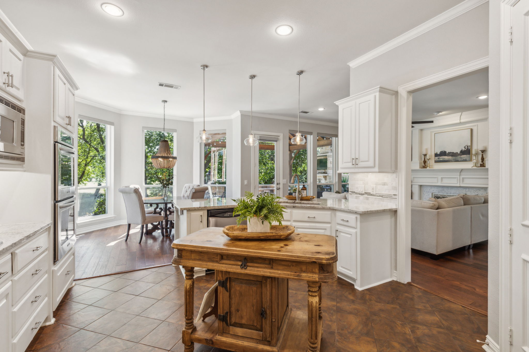 This custom-built home features an open concept that easily connects between the kitchen, family room, and breakfast area, perfect for modern living and entertaining.