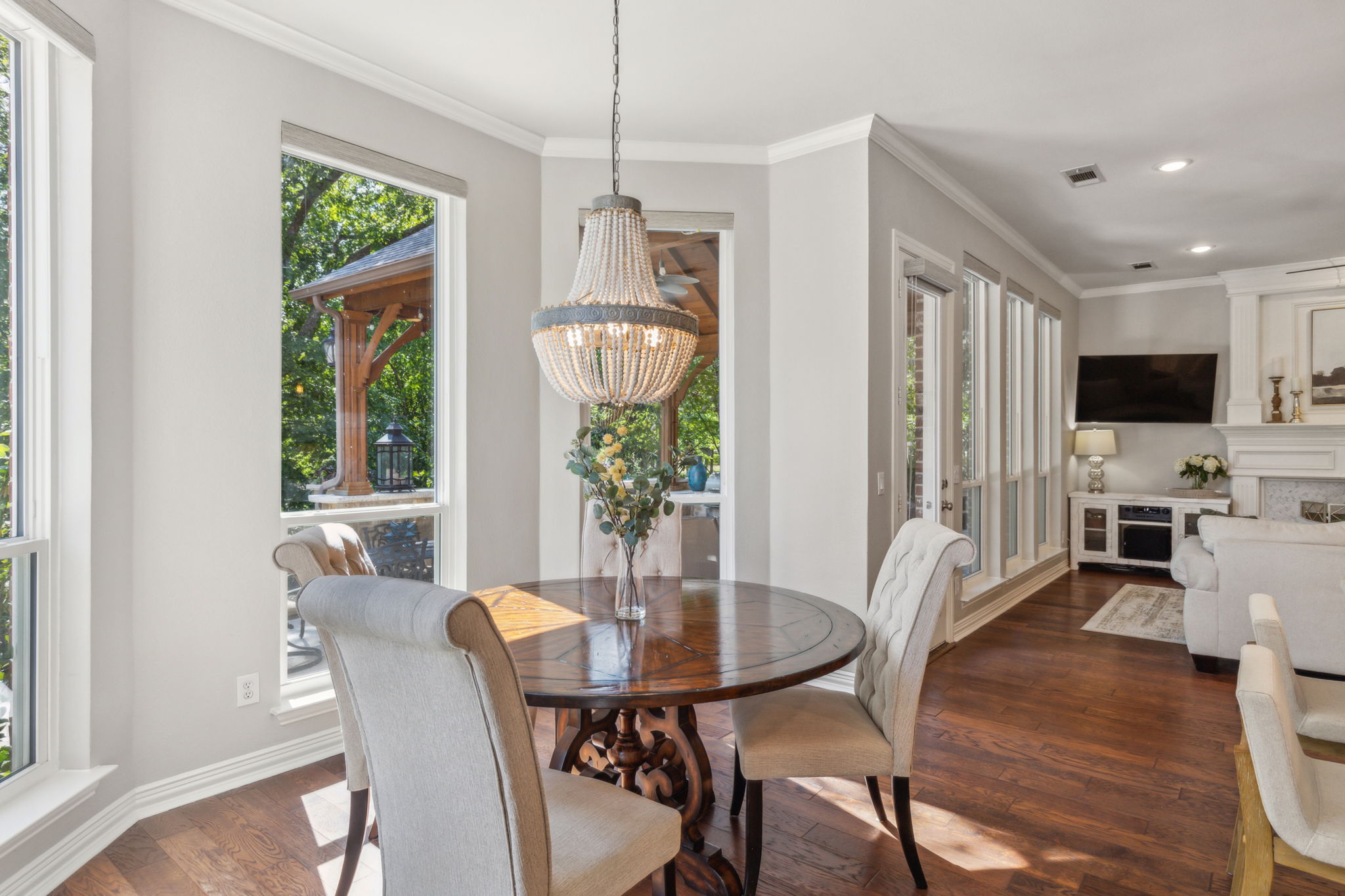 The breakfast nook, with its bay window,  provides a tranquil view of the covered patio and pool area.