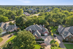 An aerial view of the residence reveals its private backyard and a lot that spans over 1/3 of an acre.