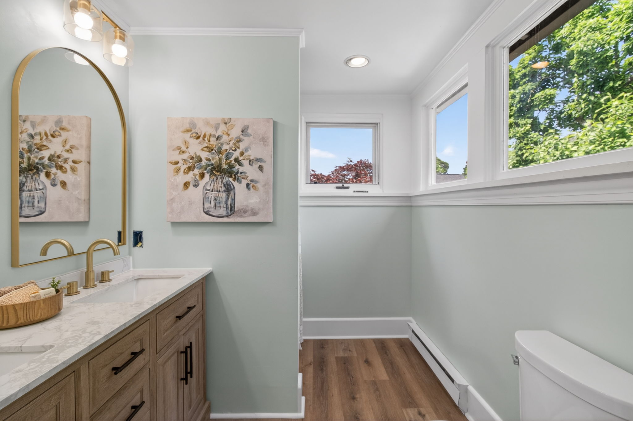 Primary bathroom with dual vanities, new LVP flooring and walk-in-shower