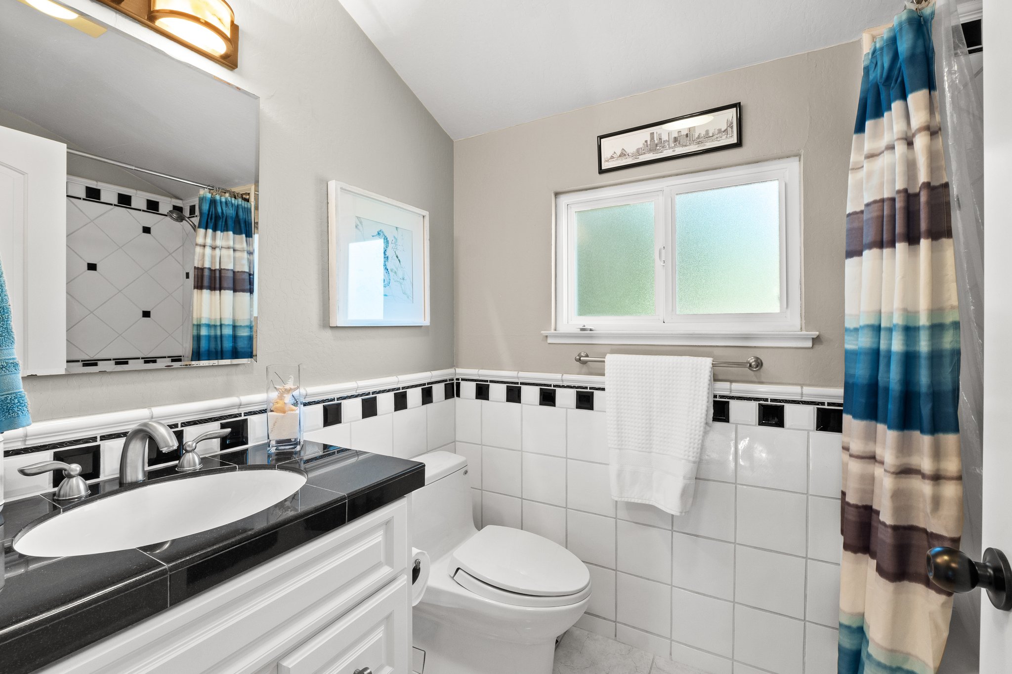 A stylish bathroom featuring a toilet and an elegantly designed washbasin.