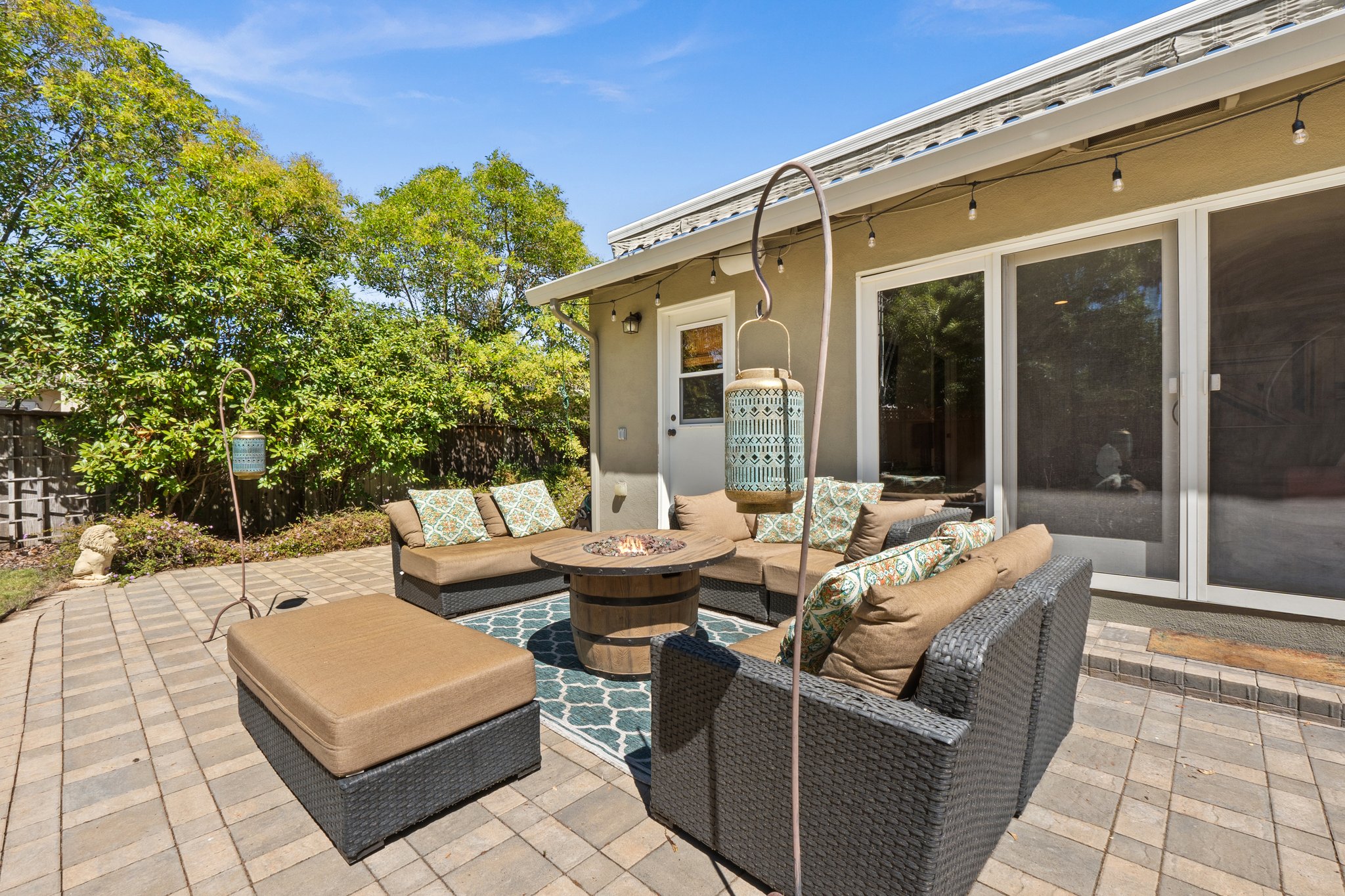 An upscale patio graced by an inviting fire pit and elegant chairs.