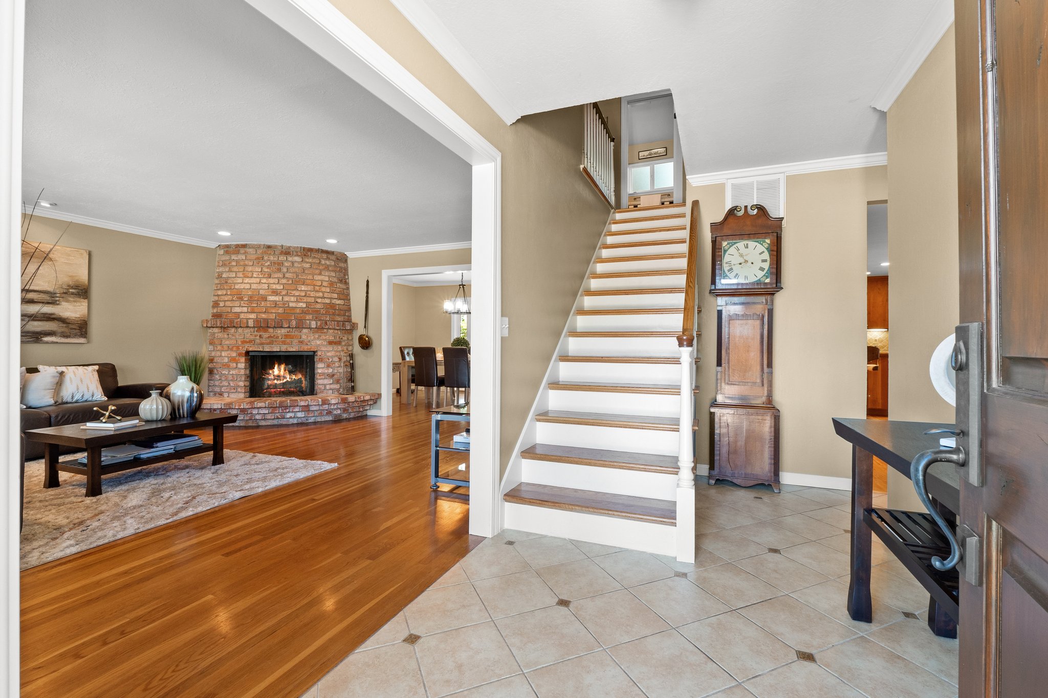 Living room with a staircase leading to second floor with four bedrooms, including a Private Master Suite.